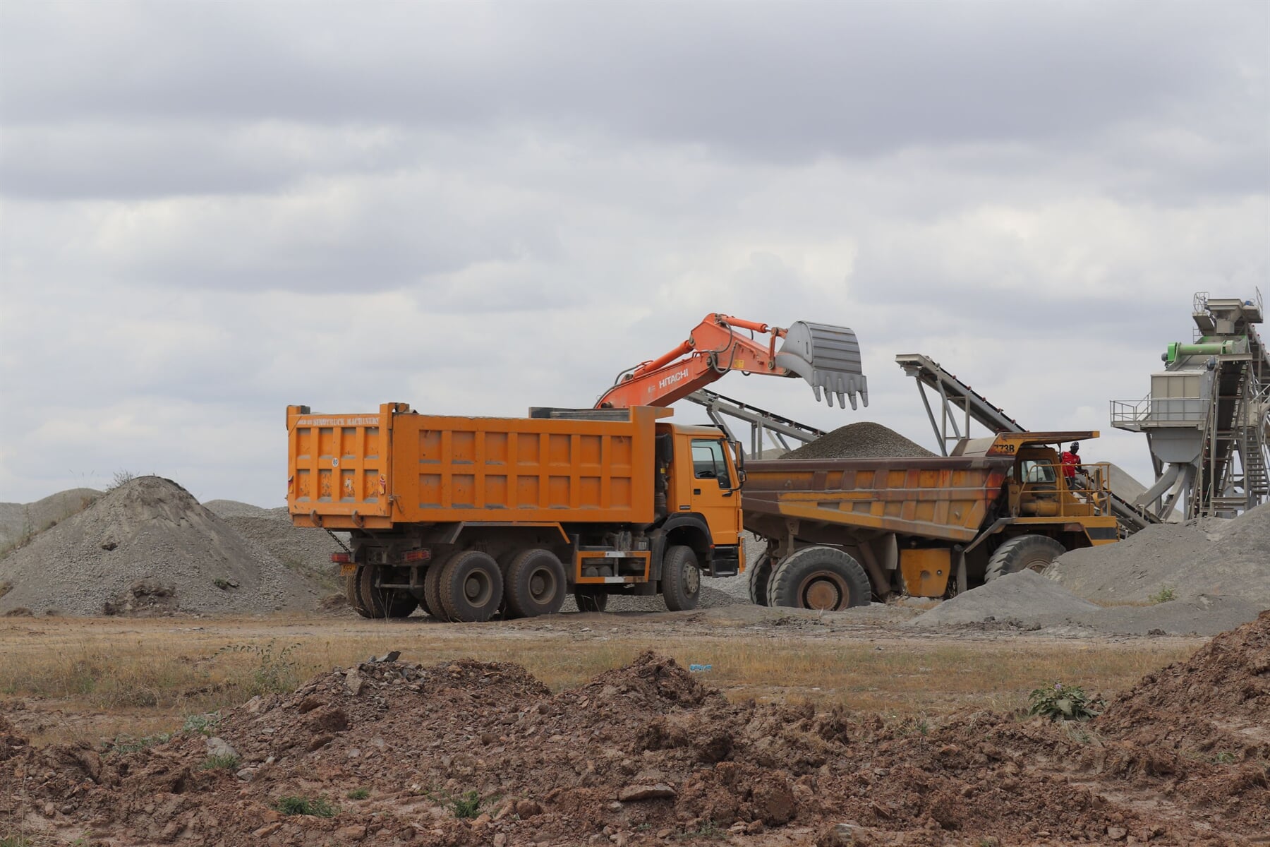 Construction-material trucks beside the loading plant